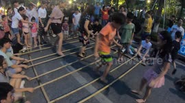 Vietnamese children perform traditional bamboo dance