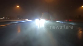 Drivers driving in torrential rain in Toronto as surprise wet weather and thunderstorms reduced visibility on the highway 401
