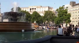People cool off in Trafalgar Square fountains