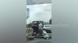 Shocking moment Filipino driver pokes motorcyclist in the eye and knocks him off before speeding away