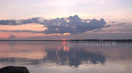 A beautiful sunset sky over a tranquil lake, time to relax and meditate.