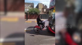 This is the moment an angry cyclist who tried and failed to bring a Santander bike onto a bus in London obstructs the double-decker
