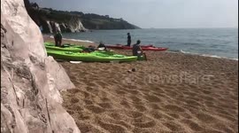 Hottest day of the year... sea kayaking group prepares to venture out to sea.