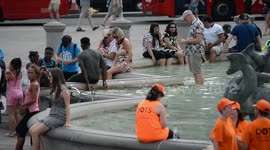 Locals and tourists cool off in London's fountains as blistering heatwave continues