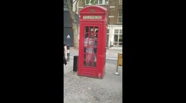 London pub goers take shelter in phone box in heatwave shower