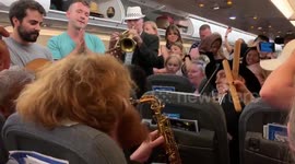 Newsflare Edit - Passengers stranded on Heathrow flight dance to band during four hour wait