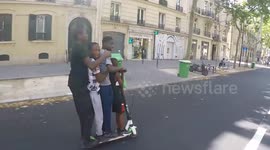 4 boys on a LimeBike scooter driving face to police agents on feet unable to go after them. Paris, avenue Dausmenil. 26 july 2019