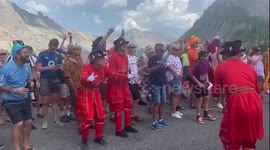 Fans dressed as British Beefeaters dance at the Tour de France