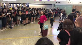 Pro-democracy protesters greet arriving passengers at Hong Kong airport