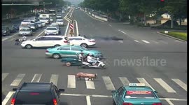 Pig wanders on busy road after falling from transport truck in China