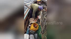 Newsflare Edit - Fisherman rescue sea turtle tangled in mass of rubbish floating in the ocean