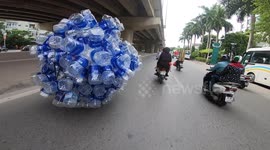 Plastic bottles automatically move? No, It was an overloaded motorcycle carrying hundreds of plastic bottles