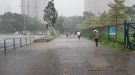 Commuters heading home in torrential rain as Tropical Cyclone Wipha edges closer to Hong Kong