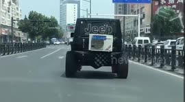 Jeep has air conditioning unit attached to its boot while driving on Chinese road