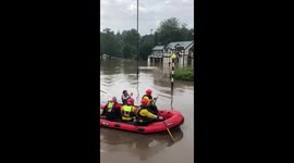 Emergency services use lifeboats to rescue stranded residents from flooding in Bramhall, Greater Manchester