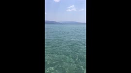Girl is having fun on a floating donut at the Greece sea
