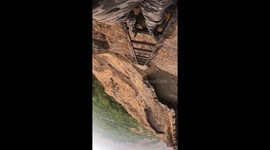 Don't look down! Indian hiker films descent down ladder on hill fort cliff-face