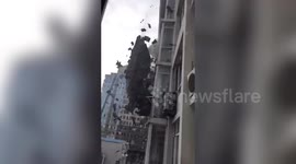Cluster of tiles slide off roof of six-storey building in China's Dalian