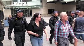 Police push back Tommy Robinson supporters from the Doors of the BBC