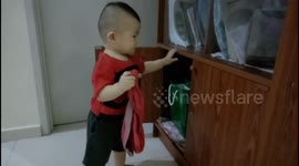 Funny toddler keeps holding dad's underwear
