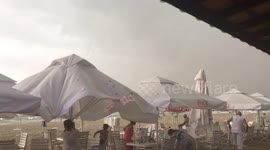 Dramatic moment flash storm lashes beach in Bulgaria, sending tourists running for cover