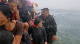 Survivors cling to capsized boat after storm kills 11 in the Philippines