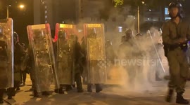 Masked youths in Hong Kong throw bricks and glass bottles at riot police