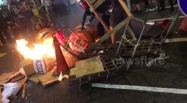 Hong Kong protesters confront police with fire barricade