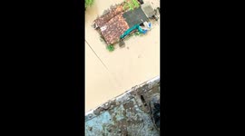 Indian Air force officer winched himself down and waded through neck deep water to save an old lady who was afraid to board the winch cradle in Gujarat India.