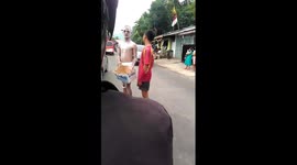 Ghost mimes 'keep smiling' to passing motorcyclist on Indonesian road