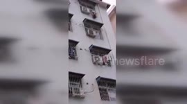 Firefighters rescue boy hanging from fourth-floor window in central China