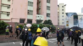 Protesters in Hong Kong hurl stones at living quarters of police as tensions mount