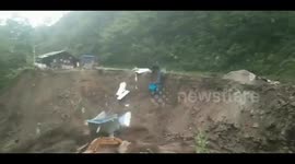 Portacabin and truck fall into river during massive mudslide in China