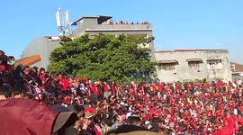 People watch soccer game free from neighbouring rooftop in Indonesia