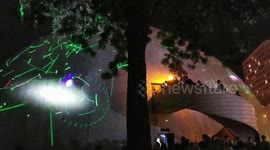 Hong Kong protesters create their own light show after student was arrested for buying laser pens