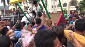 Indonesian townspeople tear apart festival cart delivering free cake