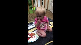 Baby making a mess with birthday cookie