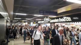Passengers surge towards announced platform at Euston station