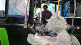 Passenger stacks up bags and bags of recycling on California bus