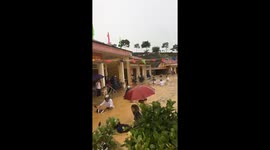 Teachers retrieve submerged belongings after flash floods cover high school in Vietnam