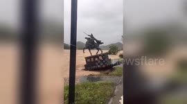 A statue in China is washed away by typhoon Lekima