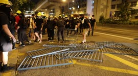 Protesters build barriers to block a main road in Kwun Tong, Hong Kong