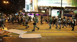 Hong Kong policeman boots traffic cone at cameraman