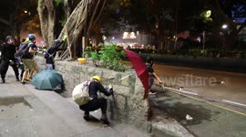 AUGUST 11: Hong Kong protesters take cover during an onslaught of rubber bullets