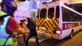 Hong Kong protesters briefly attack a police van in Kwai Fong as police are retreating