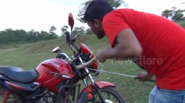 Indian motorist terrified after discovering cobra wrapped inside his bike