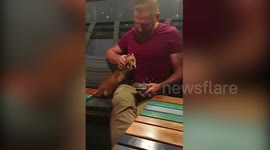Adorable moment man cozies up next to fox