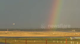 Plane lands at German airport with a stunning rainbow backdrop
