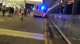 Riot police charge Hong Kong International Airport