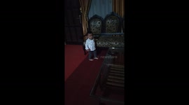 1-year-old girl goes up to the chair